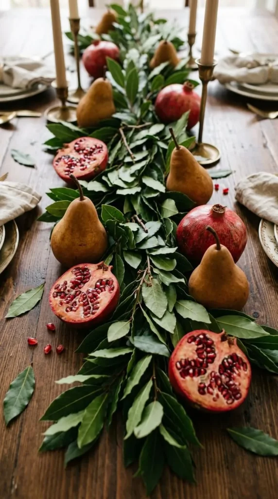 Wooden table centerpiece with green leaves, pears, pomegranates, candles arranged